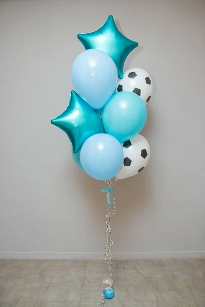 turquoise and blue balloons on the background of the wall, a latex balloon in the form of a soccer ball