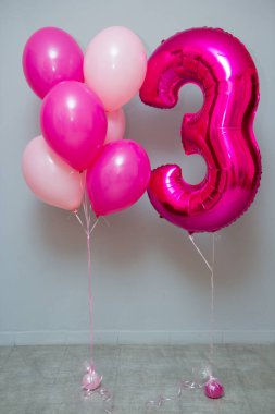 pink foil balloon number 3 in the room