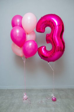 pink foil balloon number 3 in the room