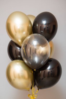 golden chrome and black balloons, bunch of balloons on wall background