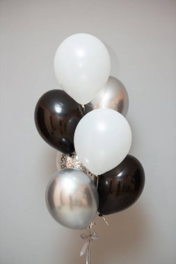 balloons for a man, silver and black helium balloons on the floor