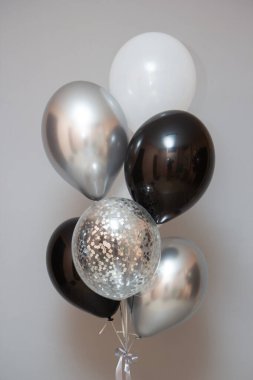 balloons for a man, silver and black helium balloons on the floor