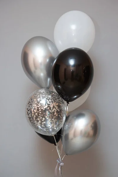 balloons for a man, silver and black helium balloons on the floor