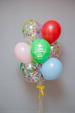 a set of multi-colored balloons and a red foil number 9 balloon, a set of bright balloons for a girl