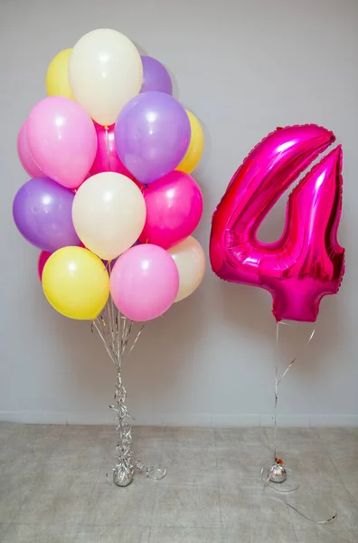 Set of colorful balloons, pink foil number 4 balloon. Decorations from balloons for a birthday for a girl