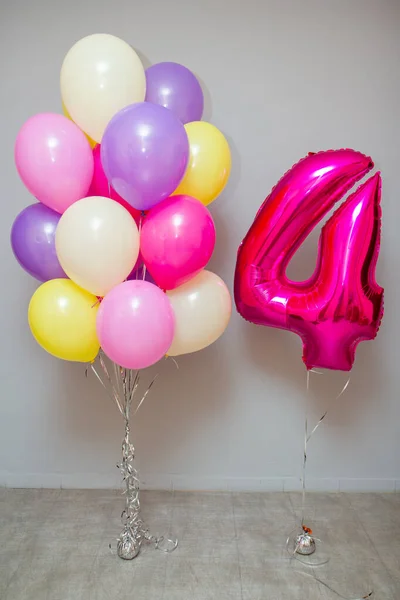 Set of colorful balloons, pink foil number 4 balloon. Decorations from balloons for a birthday for a girl