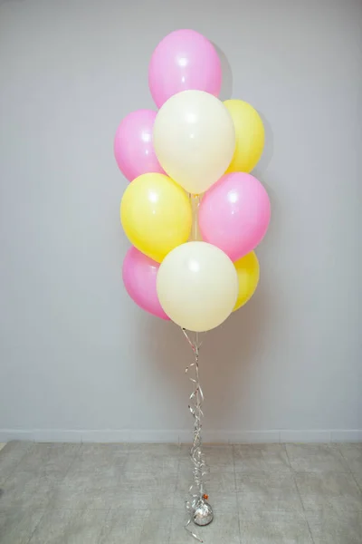Set of pink and yellow balloons. Decorations from balloons for a girl