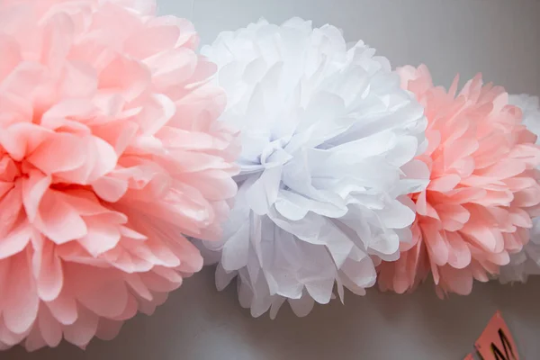 pink and white paper pom-poms and flowers