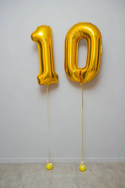 golden balloons number 10 on white background