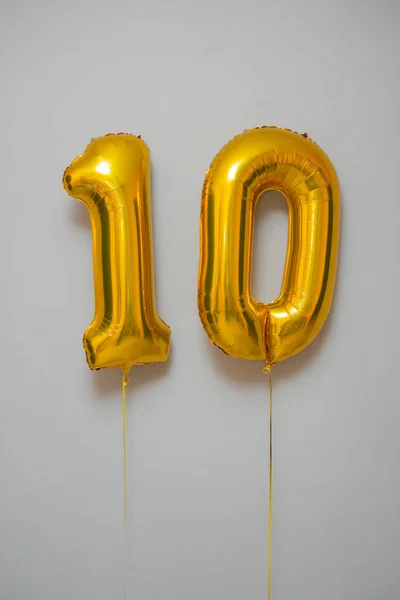 golden balloons number 10 on white background