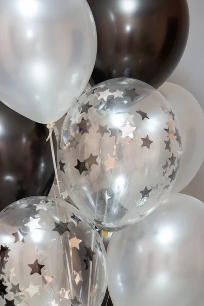 black and silver balloons with helium in the interior