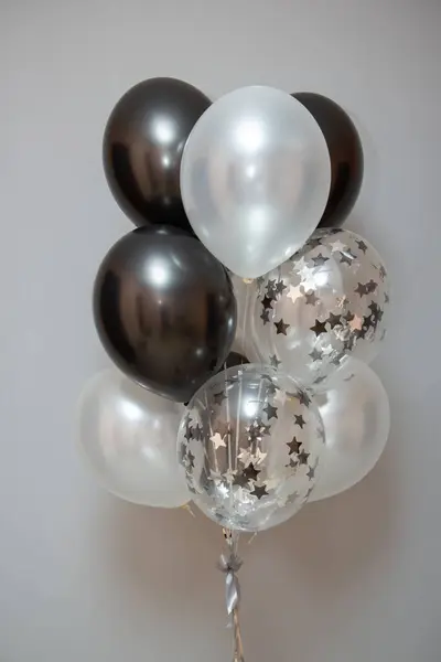 black and silver balloons with helium in the interior