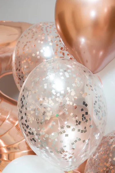 golden and white balloons on white background, rose gold helium balloons