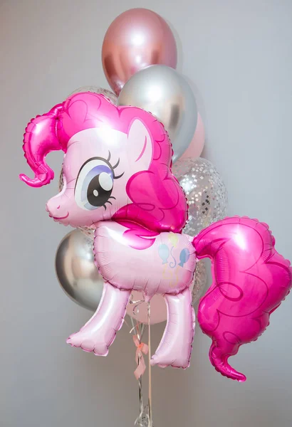 pink pony on a background of balloons, girl's birthday