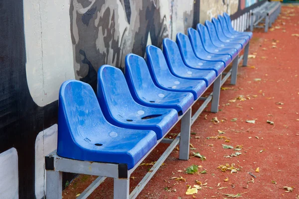blue fan chairs on the football field