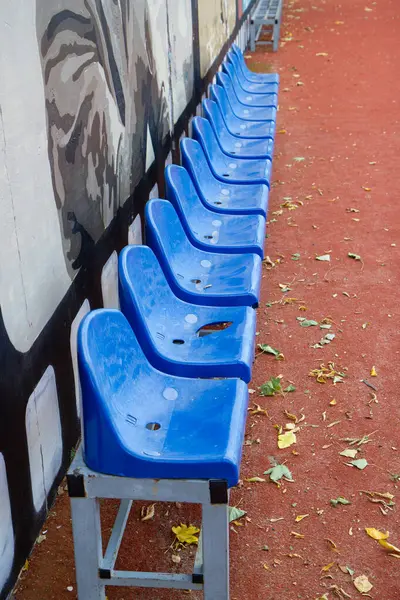 blue fan chairs on the football field