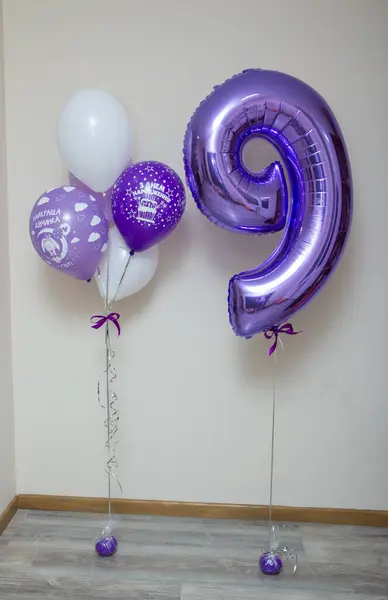 purple number 9 balloon, purple balloons, inscription on the balloon \