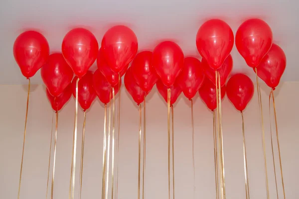 red helium balloons on the ceiling