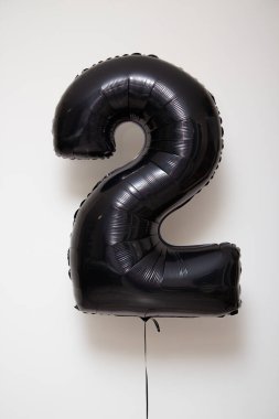 Beyaz arka planda iki numaralı siyah balon, 2 numaralı folyo.