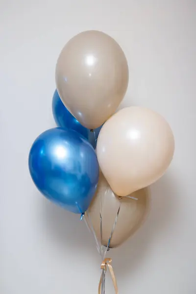 blue and beige birthday balloons, helium balloons on a white background