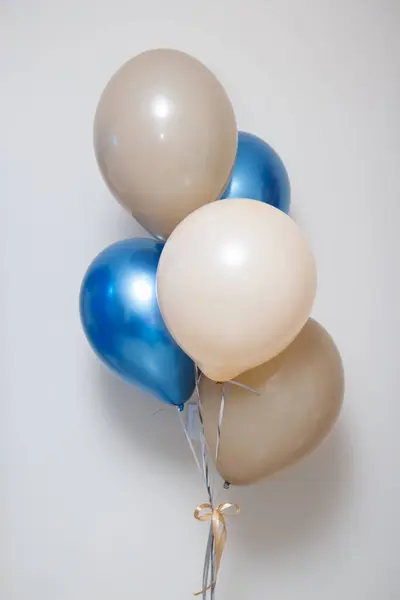 blue and beige birthday balloons, helium balloons on a white background