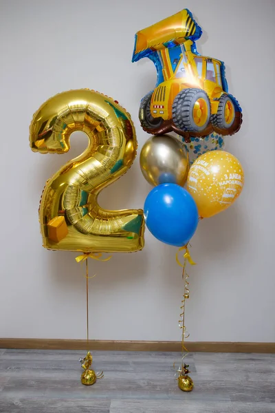 golden number 2 balloon, foil tractor balloon, inscription on the balloon 