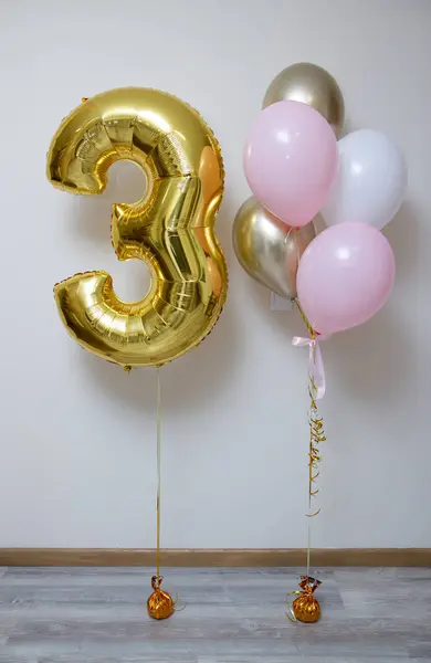 golden number 3 and pink and white balloons