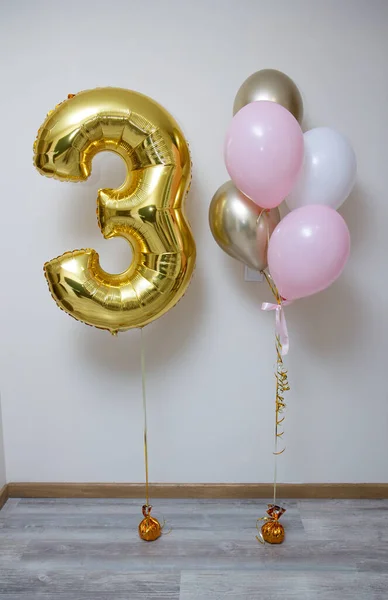 stock image golden number 3 and pink and white balloons