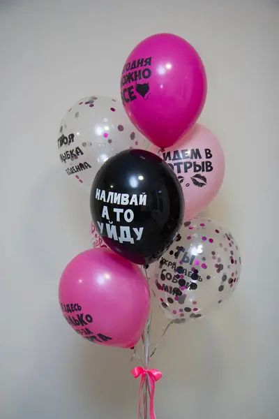 set of black and pink helium balloons