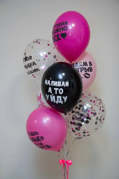 set of black and pink helium balloons