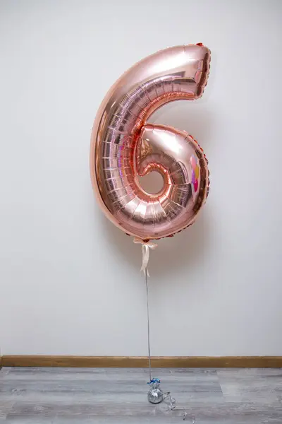 pink number six foil balloon on white background, foil number with helium
