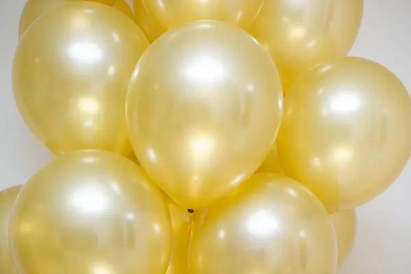mother of pearl gold balloons with gold ribbons