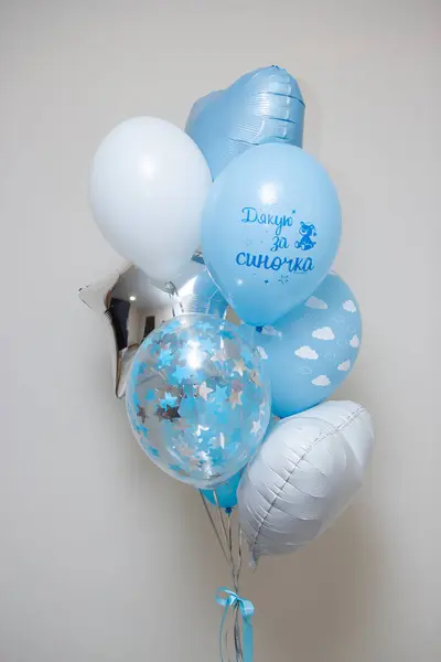 a set of blue and white balloons for discharge from the maternity hospital on a white background, the inscription \