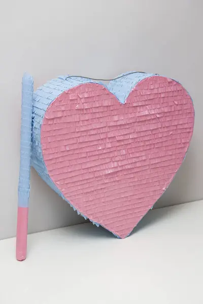 stock image pink blue heart made of cardboard, piata heart with candies for a children's party