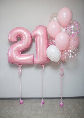 Beyaz arkaplanda 21 numaralı pembe balonlar
