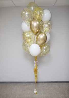 Bir buket altın, beyaz ve berrak konfetili balonlar