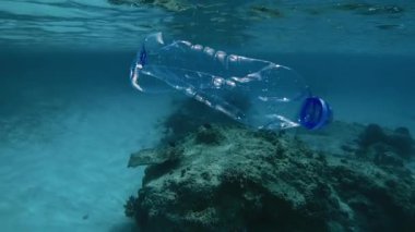 Denizde yüzen bir plastik şişe. Su altı kirliliği deniz yaşamını tehlikeye atıyor ve su ortamının dengesini bozuyor..