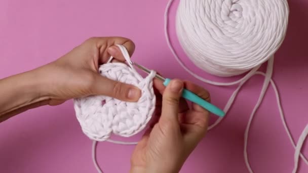 Top View Womans Hands Crocheting Ribbon Yarn Pink Background High — Stock Video