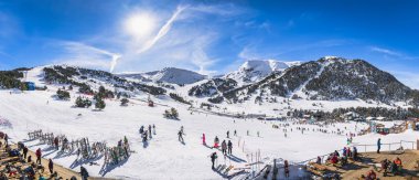 El Tarter, Andorra, Jan 2020 Wide, panoramic view on bars and restaurants, ski slopes and mountains on a sunny day. People enjoying winter holidays