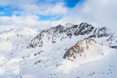 Dramatics mountain landscape with snow capped rocky Pyrenees mountains. Ski winter holidays in Andorra, El Tarter, Grandvalira