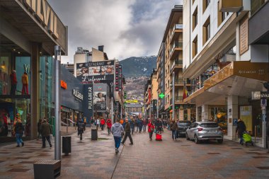Andorra la Vella, Andorra, Jan 2020 People, tourists walking and shopping on promenade with shops, restaurants and mall, Pyrenees Mountains