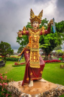 Bali, Indonesia, 4 Oct 2024 A colorful statue beautifully showcasing traditional dance attire in Ulun Danu Beratan Temple, set against a picturesque garden backdrop, symbolizing rich cultural heritage clipart