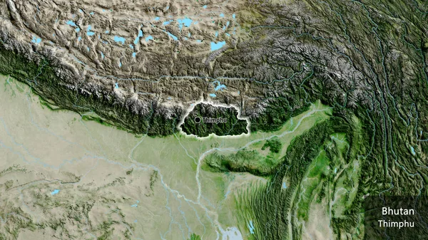 stock image Close-up of the Bhutan border area on a satellite map. Capital point. Glow around the country shape. English name of the country and its capital