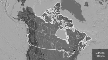 Kanada sınır bölgesinin ve onun bölgesel sınırlarının bir bileklik haritası üzerinde yakın çekimi. Ana nokta. Ülke çapında parıldıyor. Ülkenin ve başkentinin İngilizce adı