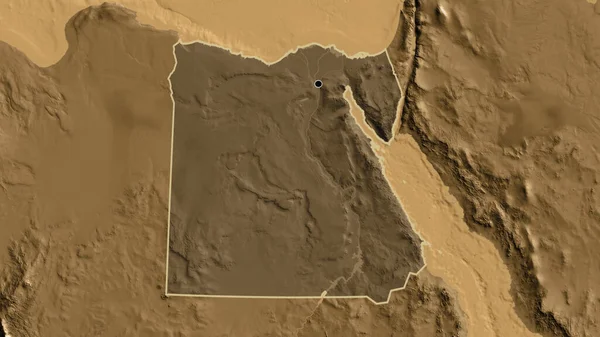 stock image Close-up of the Egypt border area highlighting with a dark overlay on a sepia elevation map. Capital point. Outline around the country shape. 