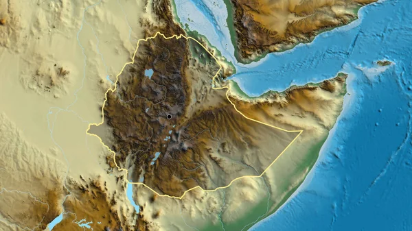 stock image Close-up of the Ethiopia border area highlighting with a dark overlay on a relief map. Capital point. Outline around the country shape. 
