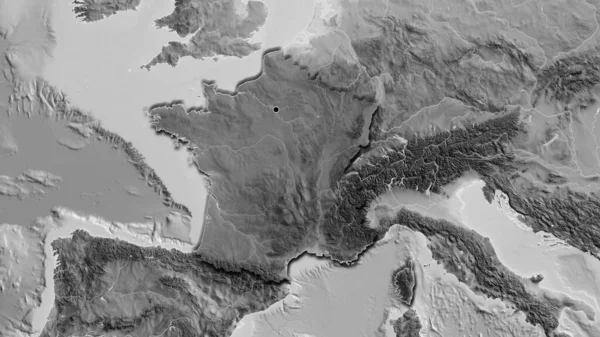 Close-up of the France border area highlighting with a dark overlay on a grayscale map. Capital point. Bevelled edges of the country shape.