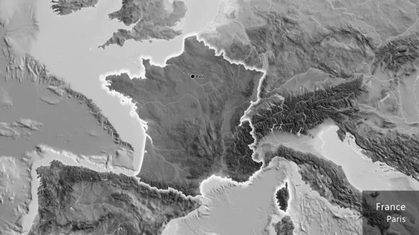 Close-up of the France border area highlighting with a dark overlay on a grayscale map. Capital point. Glow around the country shape. English name of the country and its capital