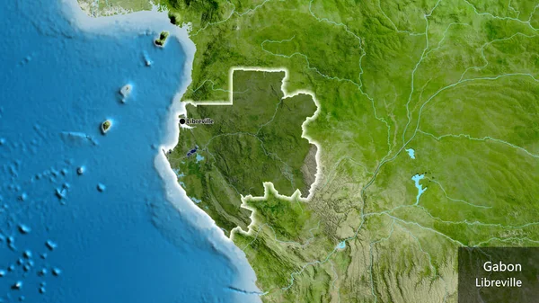 stock image Close-up of the Gabon border area highlighting with a dark overlay on a satellite map. Capital point. Glow around the country shape. English name of the country and its capital