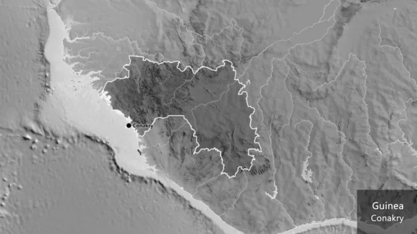 ギニア国境地域のクローズアップは グレースケールの地図上の暗いオーバーレイで強調されています 資本ポイント 国の形の周りの概要 英名国とその首都 — ストック写真